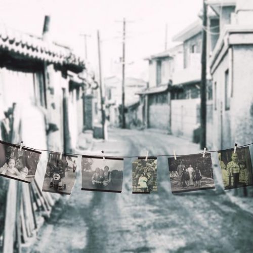 Picture of an alleyway with pictures hanging on string.