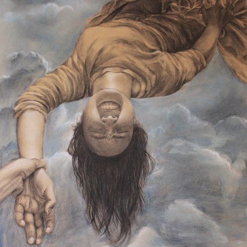 Picture of girl upside down and smiling.